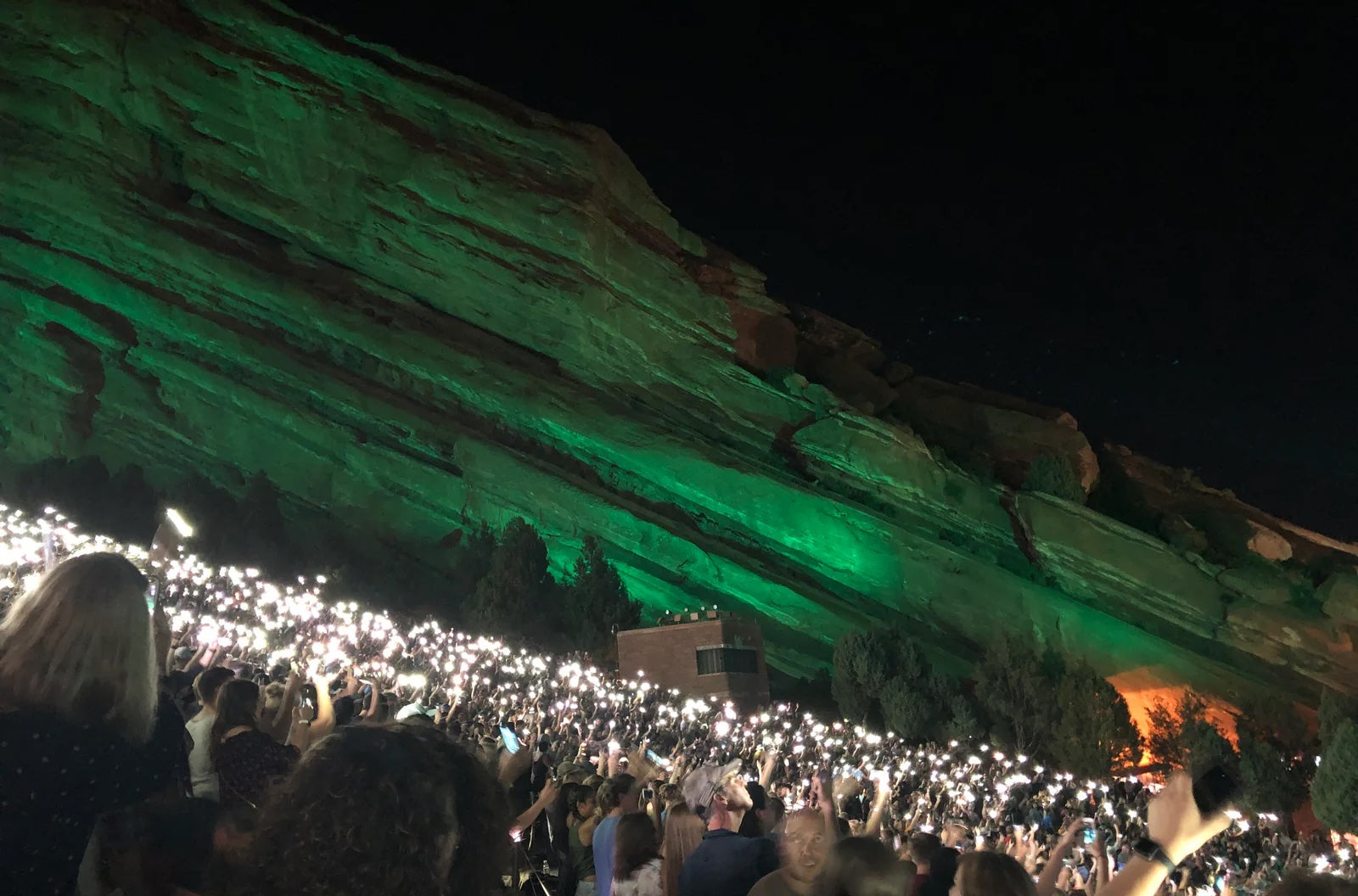 people at a nighttime concert at red rocks