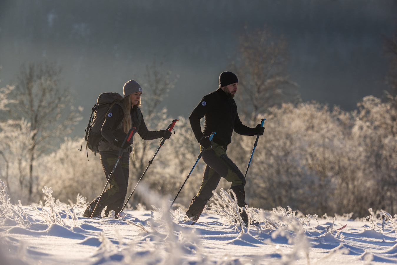 man and woman snowshoeing in aclima clothing