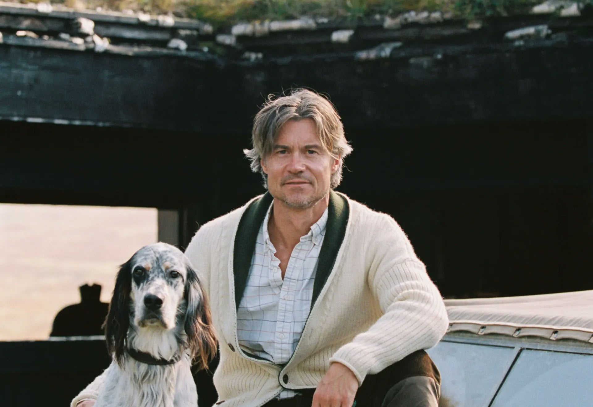 man wearing amundsen sports cardigan with his dog