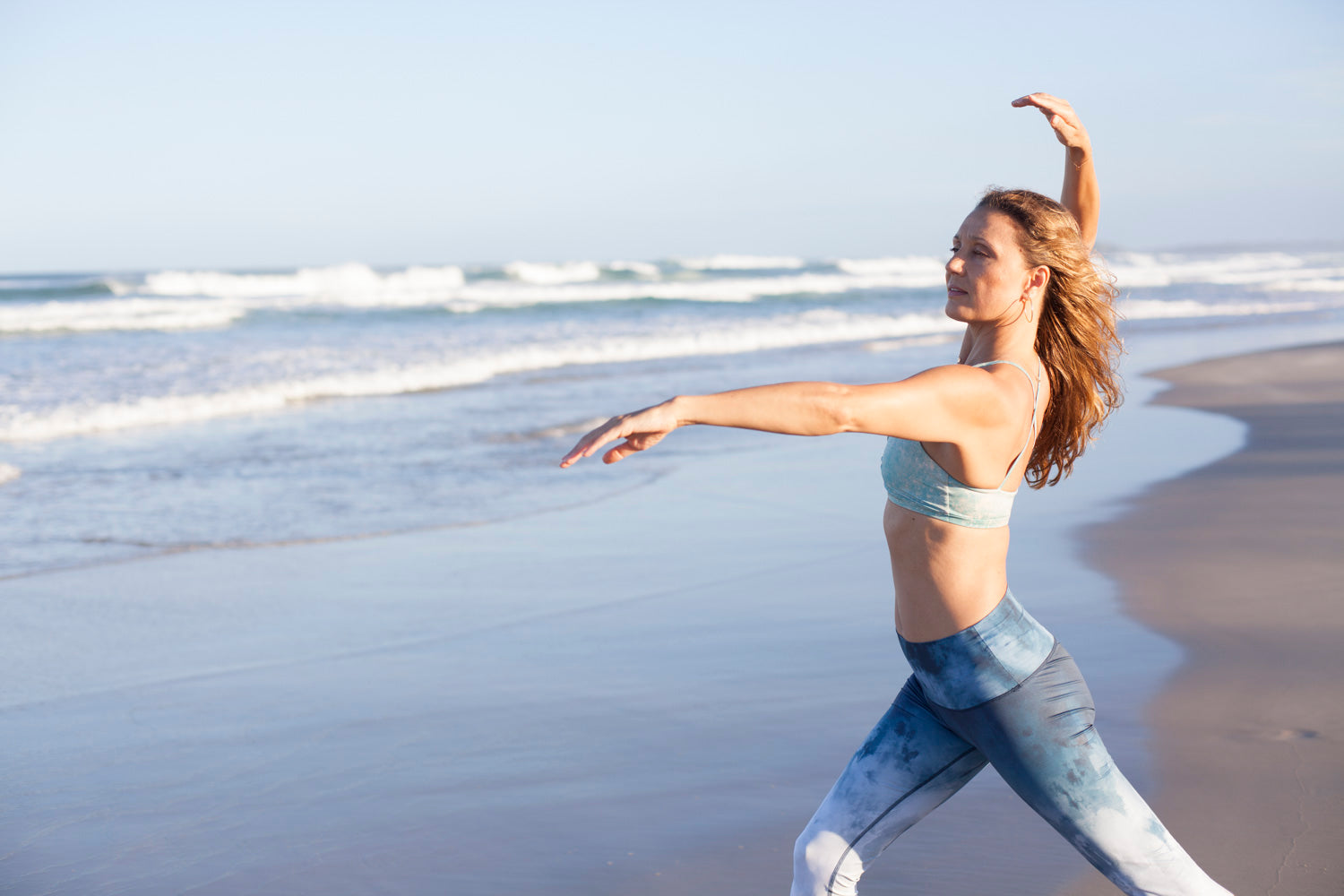 woman wearing yoga clothes on the beach