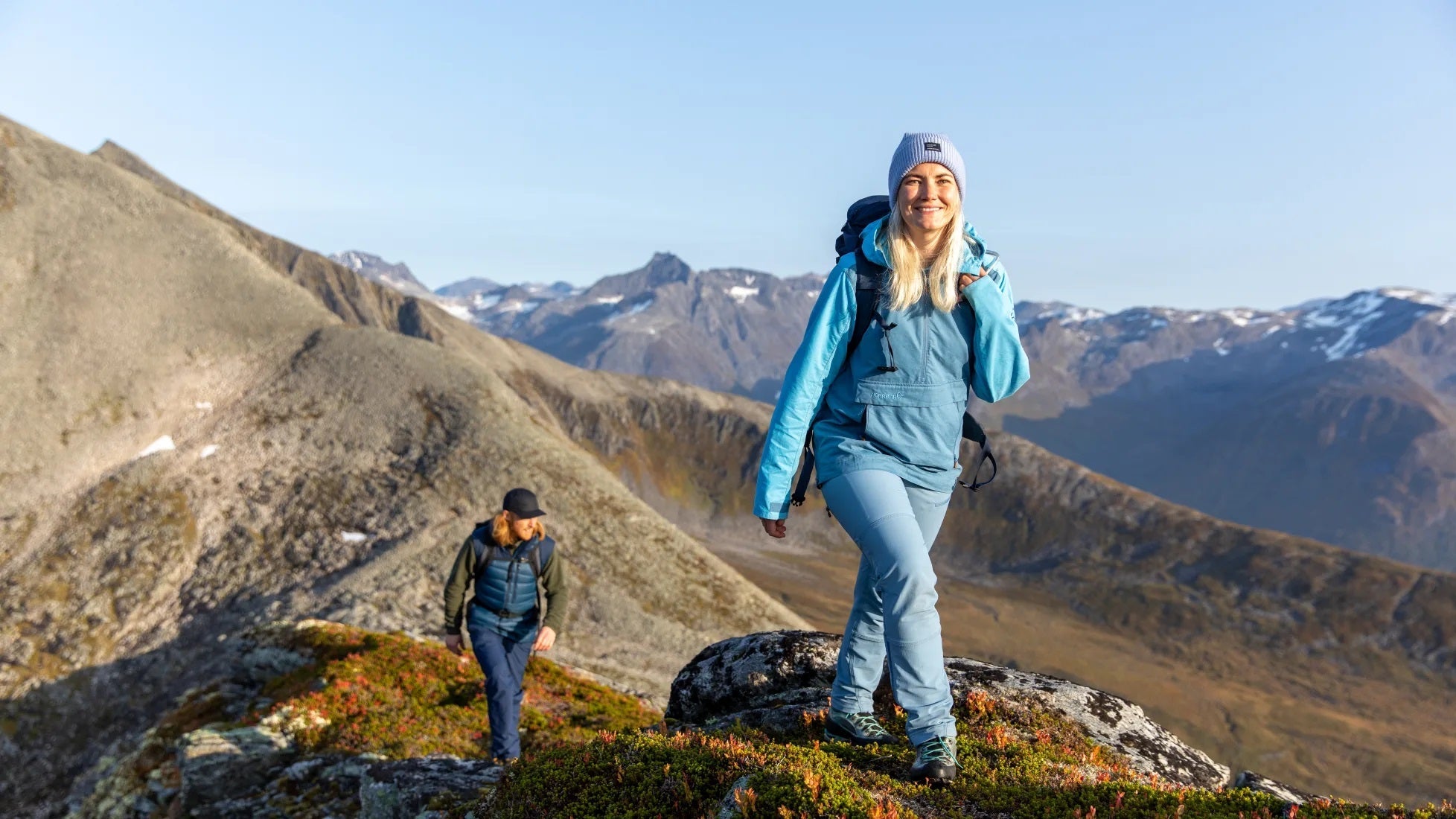 couple hiking in norrona clothing