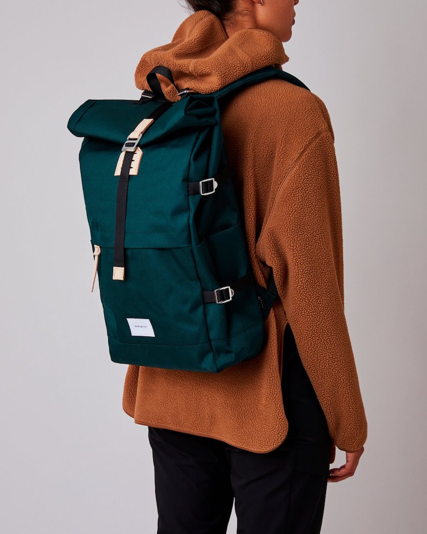 woman wearing sandqvist bernt backpack in dark green