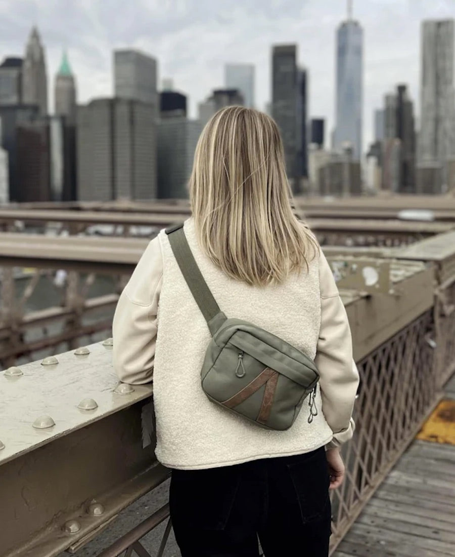 woman wearing adventurist backpacks co summit sling bag in pine