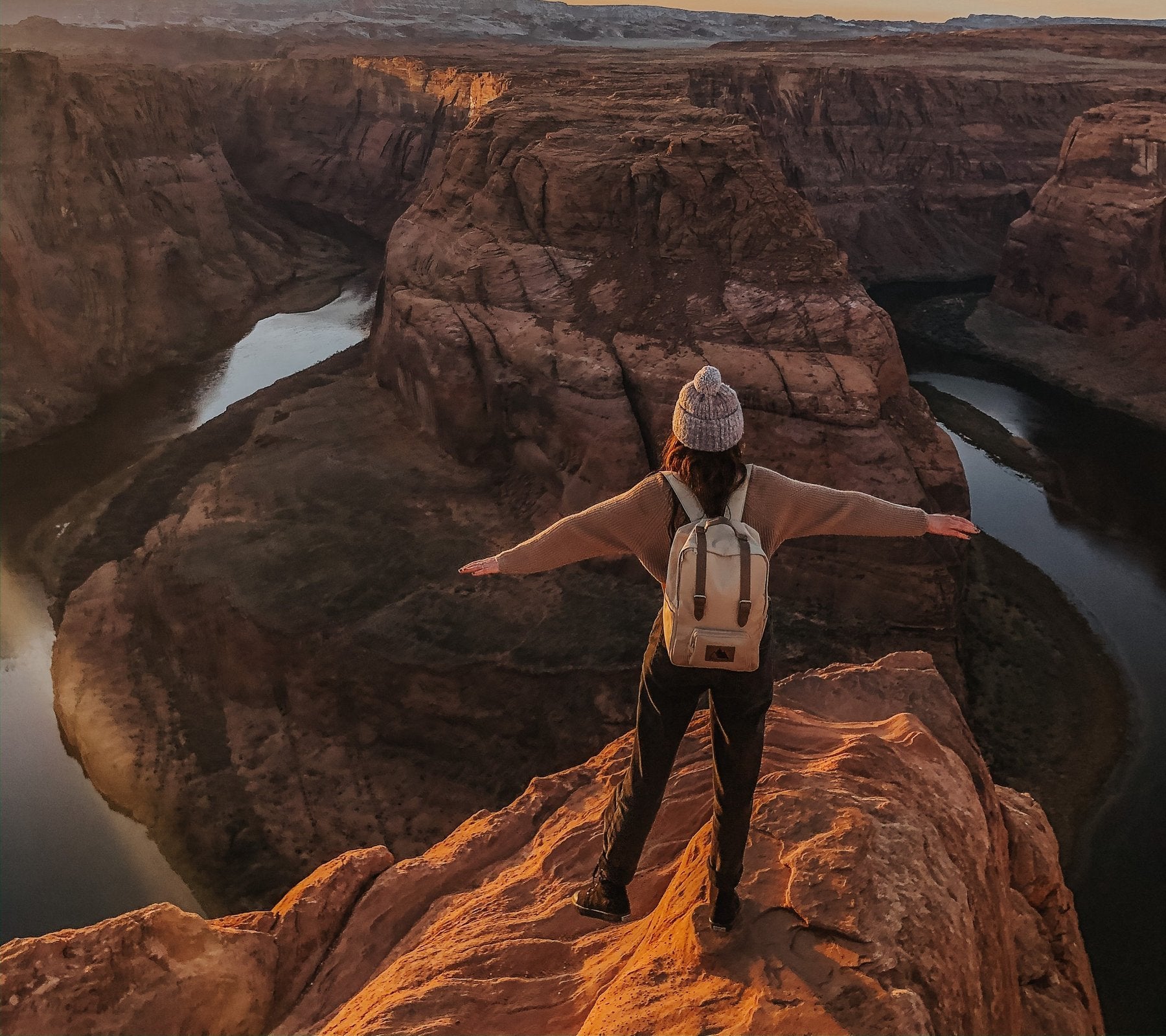 woman wearing an adventurist backpack while hiking near the colorado river