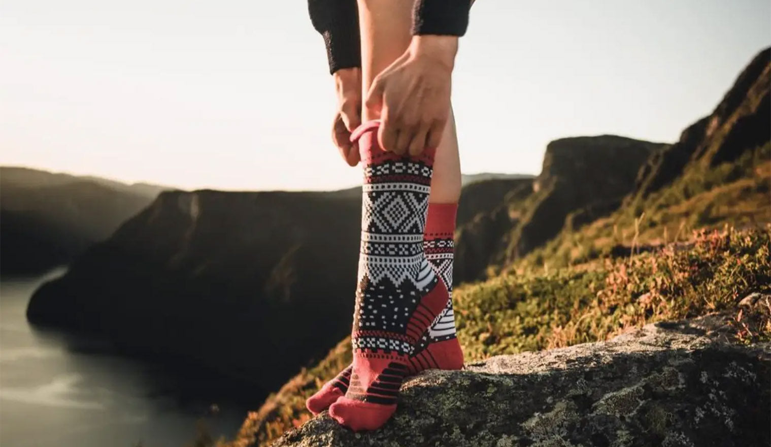 backpacker in norway wearing nvrlnd socks