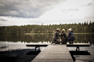 family on a dock wearing hestra gloves