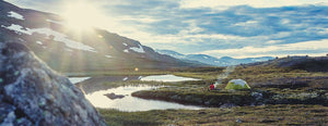 backpacker waking up to nature in haglofs scandinavian outdoor clothing