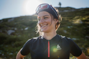 woman trail running in odlo running clothes