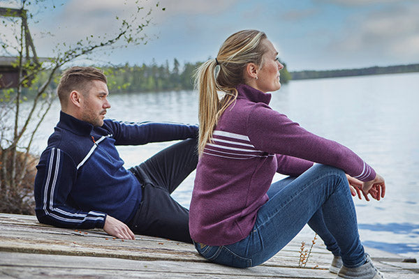 couple sitting on a dock in ivanhoe of sweden wool zip up sweaters