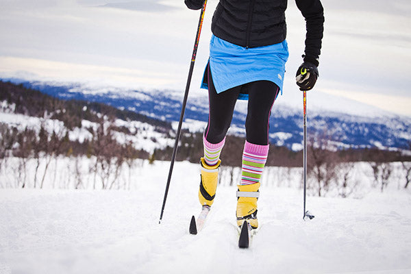 woman cross country skiing in skhoop down skirt