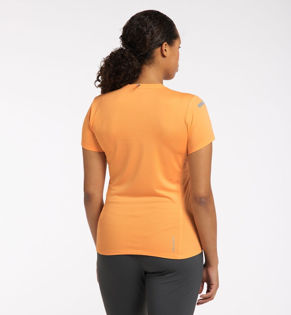 Back view of model in orange L.I.M. Tech Tee.