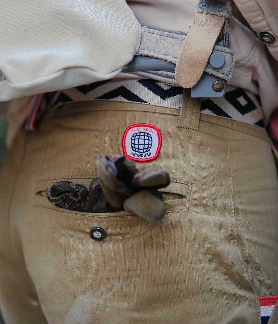 Close up view of gloves sticking out of the back pocket of 8incher boulder shorts.