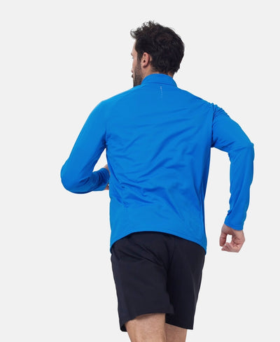 Back view of model in running position wearing Essential half zip in electric blue.