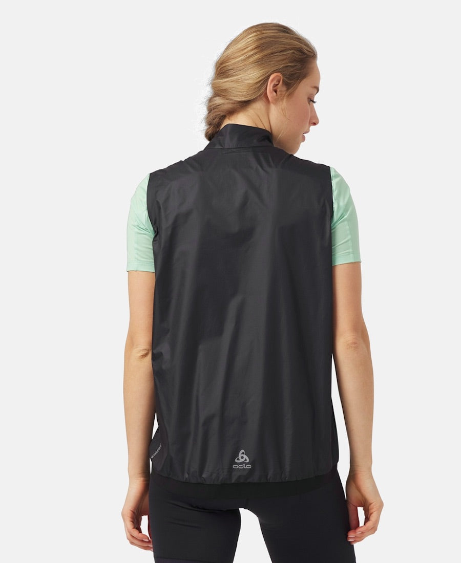 Back view of model wearing essential windproof vest in black.