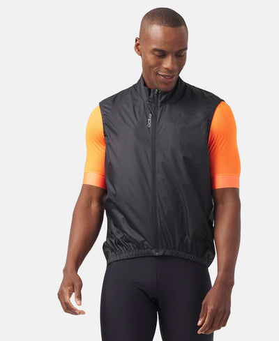 Front view of model wearing essential windproof vest in black.