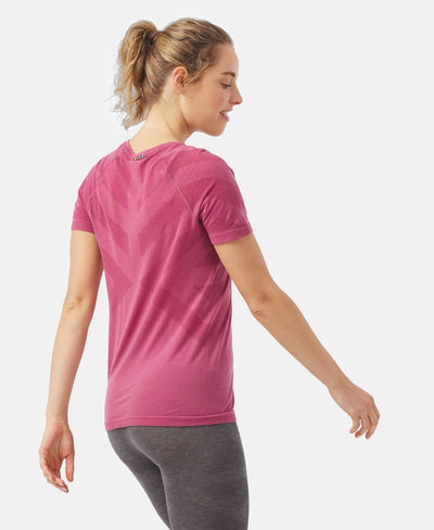 Back view of model wearing Kinship Light short sleeve T-shirt in pink.
