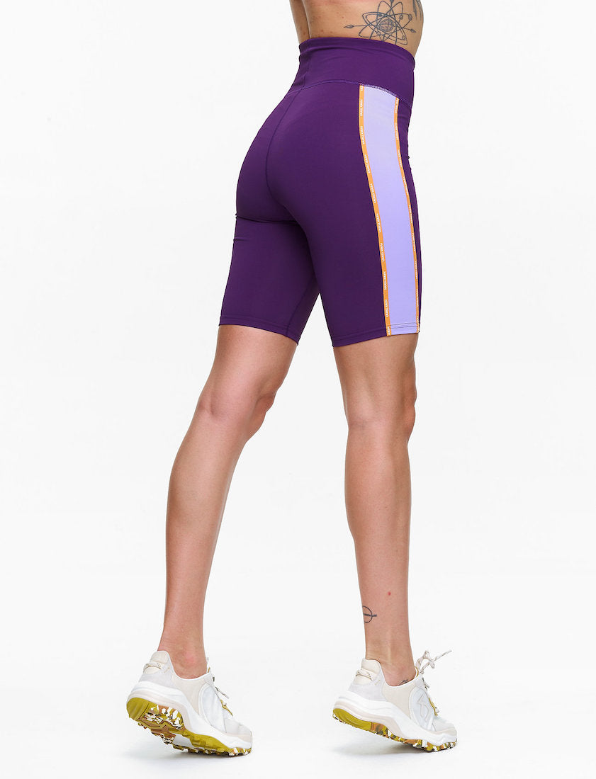 Back view of model wearing Janni shorts in purple.