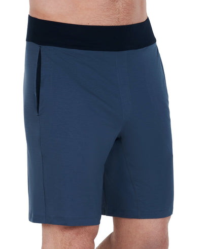 Side view of model in sleep shorts in blue.
