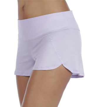 Front/side view of model wearing stay cool sleep shorts in purple/pink.