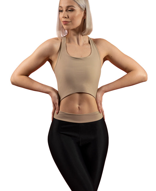 Front view of woman wearing sand VanillaShanti one-piece yoga bodysuit or unitard