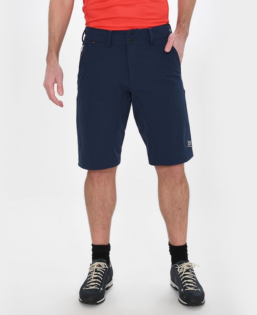 Front view of model wearing Versatility shorts in dark blue.