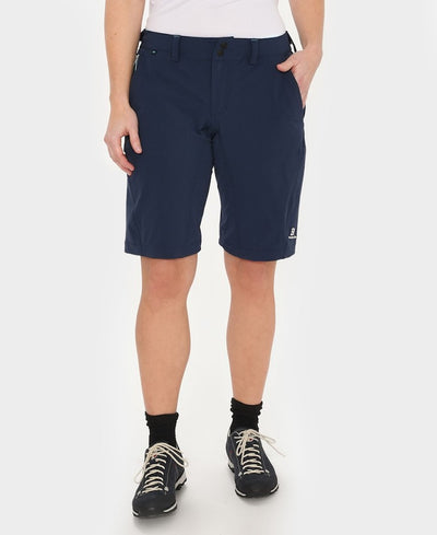 Front view of model wearing Versatility shorts in navy.